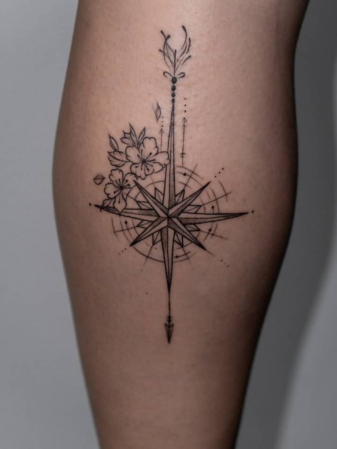 Floral star compass tattoo on the calf