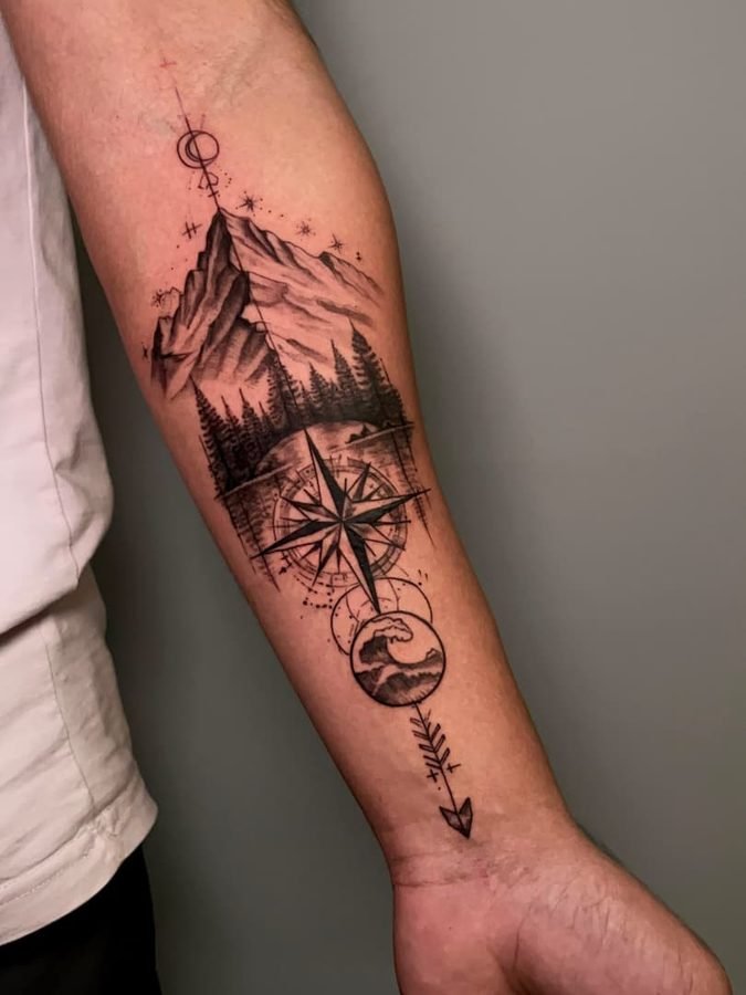 Mountain, lake, wave, and arrow compass tattoo