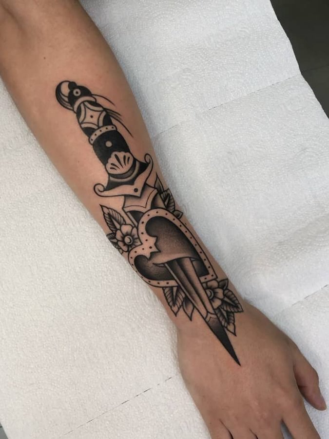 Traditional dagger tattoo with snake-head pommel