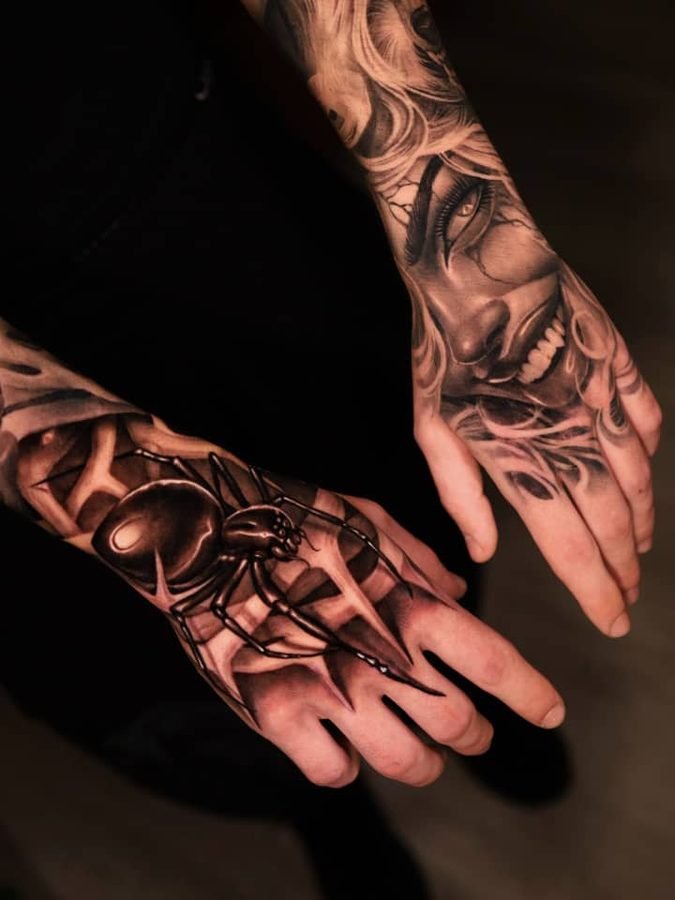 Spider and face tattoos across two hands