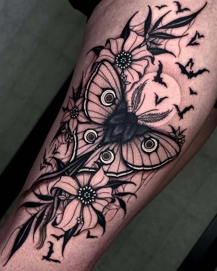 Moth with flowers, bats, and moon tattoo