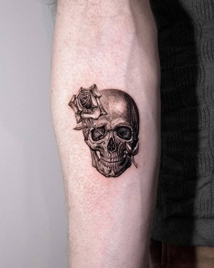 Small skull and rose tattoo on forearm