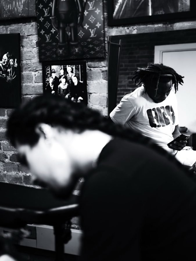 Candid black and white photo inside the MAZ Tattoo studio