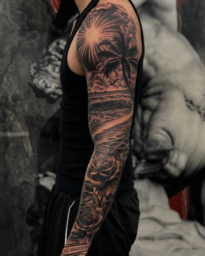 Full sleeve tattoo of a tropical sunset beach scene with roses