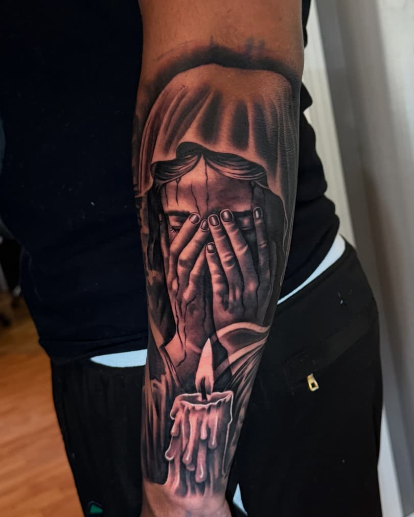 Half sleeve forearm tattoo of a weeping veiled woman and a candle