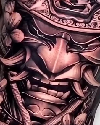Torso tattoo of an ornate samurai mask and armor, tattooed in a single marathon session